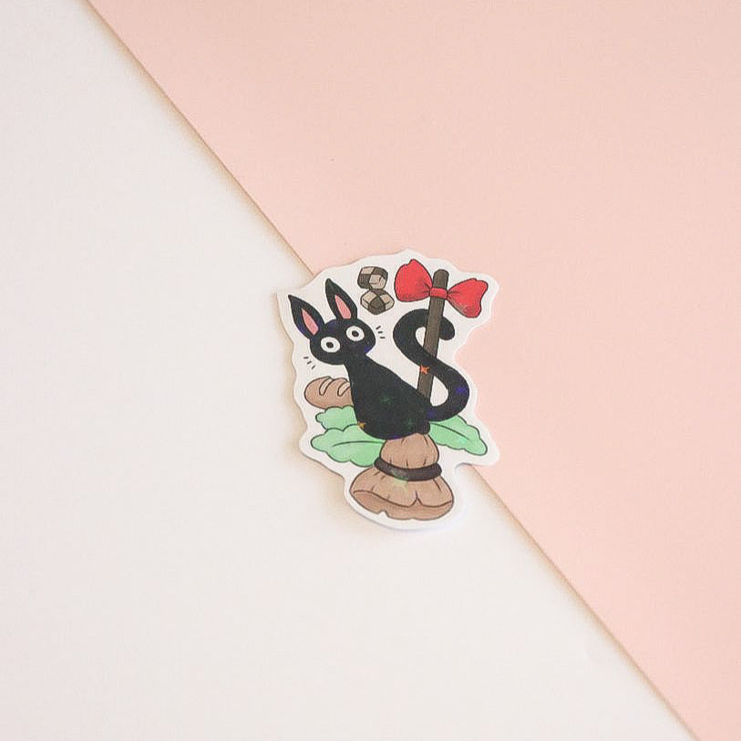 Sticker of a cartoon character with a red bow on a pink and white background