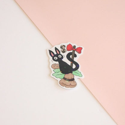Sticker of a cartoon character with a red bow on a pink and white background