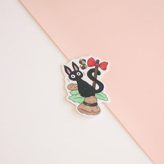 Sticker of a cartoon character with a red bow on a pink and white background